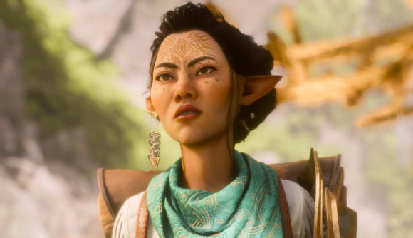 Dragon Age The Veilguard trades goofy blood for "convincing" gore: An elf woman with black hair, facial tattoos and one earing frowns at something off camera, wearing a huge rucksack and a green scarf with golden patterns