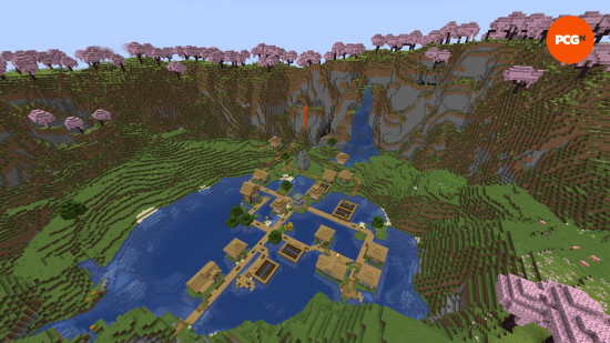 A large village sits on a lake under a cherry grove in one of the best Minecraft seeds.